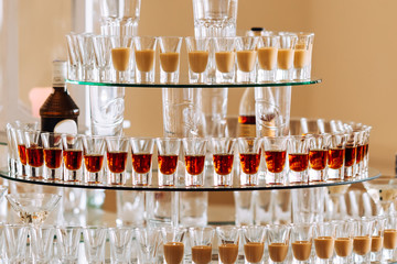wedding. transparent tiered stand with different alcohol drinks