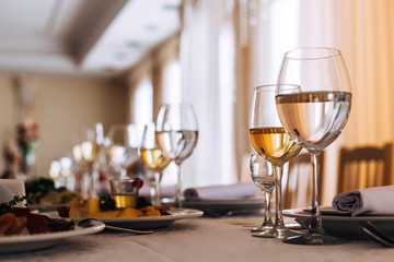  glasses set in restaurant. wineglass with drink. table for gues
