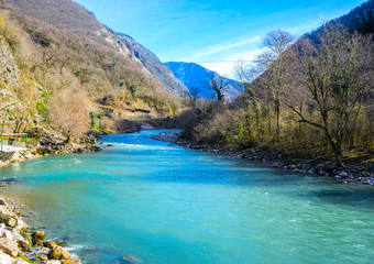 Fototapeta na wymiar Beautiful mountain river with turquoise color water flowing down the gorge