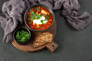 Red borscht with dill in ceramic  bowl