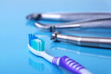 dental care toothbrush with dentist tools on mirror background