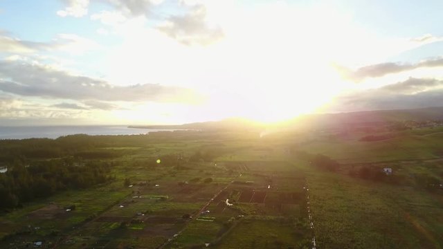 aerial bird eye view of mauritius island,forest,farm,fields and ocean against the brighter sun sky and super white clouds.filmed with drone 4K 30fps