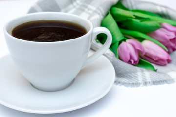 Bouquet of spring flowers, pink tulips on checkered plaid background with a cup of coffee - holiday business card for 8 march, Valentine day or mother's day
