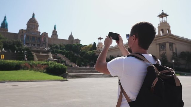 Tourist taking pictures on smartphone sightseeing.