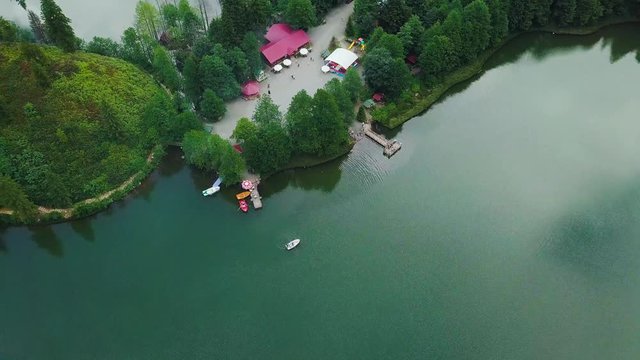 4K hd aerial drone shot, in fast motion, people walking between lakes, houses, next to Lake :Karagol, in Borcka District, Artvin Province, Turkey