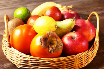 Naklejka na ściany i meble Fresh mixed exotic fruits in basket. Fruits background. Healthy eating, dieting.