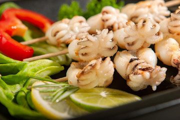 Baby cuttlefish grill on a wooden skewer