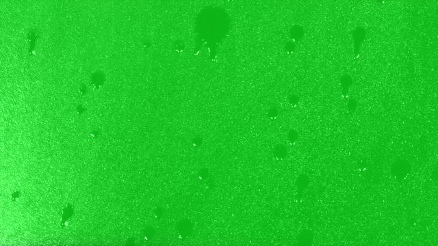 Surface Rainstorm on green background. Realistic rain and water droplets with chroma key green screen background 