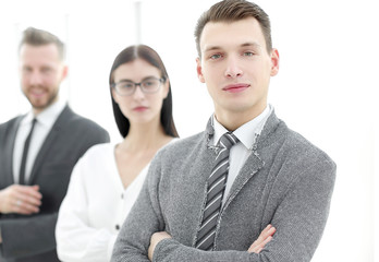young businessman standing in front of his business team
