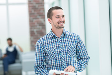 modern man standing near the office window .