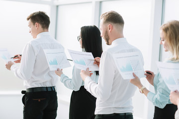 close up. employees with financial reports standing in line