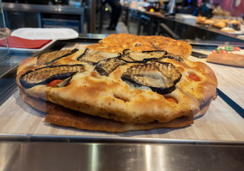 italian flat bread pizza on table in restaurant kitchen