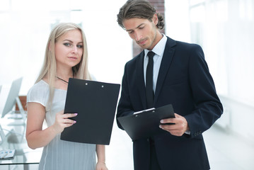 businessman and businesswoman discussing documents before the meeting