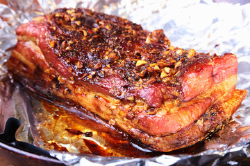 Obraz na płótnie Canvas Sliced grilled pork ribs barbecue Striploin steak with chimichurri sauce and tomatoes on cutting board on dark background.
