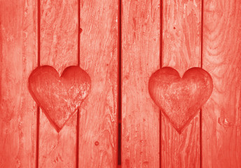 Two heart shapes carved in vintage wood close up