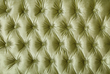 Green capitone tufted fabric upholstery texture