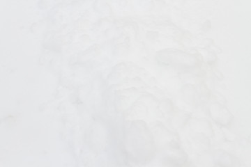 White fluffy snow just fell on the road in winter