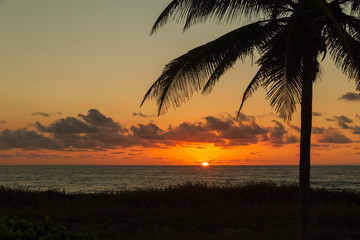 Fototapeta na wymiar The sun peaking out from the horizon on Delray Beach in Florida.