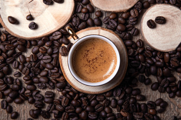 A cup of coffee with coffee beans