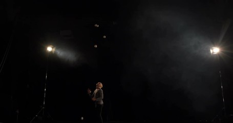 Fail - circus juggler on the black stage.