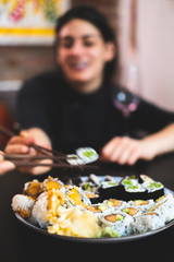 Woman eating homemade vegan sushi