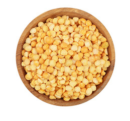 yellow split peas in a wooden bowl isolated on white background. Top view