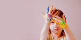 Cuute little child girl with colorful painted hands. Free space for text.