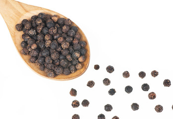 Close up heap of black pepper in wooden spoon, peppercorns isolated on white background, dried spice pepper corn concept