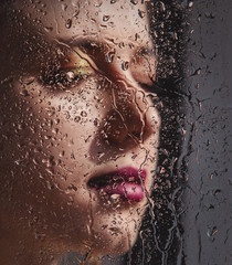woman with makeup and earring with rain drops