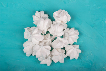 delicious meringue on turquoise background