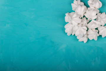 delicious meringue on turquoise background