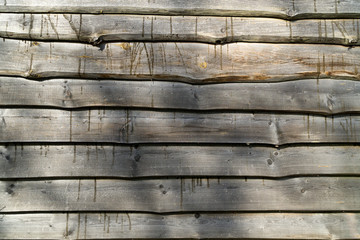 Fence from horizontal raw old gray old boards. Wood texture background.