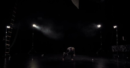 Amazng circus juggler makes tricks on the stage.