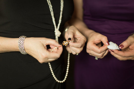 Mature hands holding jewelry