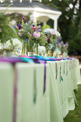 Green and pastel colorful table decor at a summer wedding reception