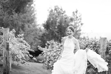 Fototapeta na wymiar Laughing bride holding wedding dress