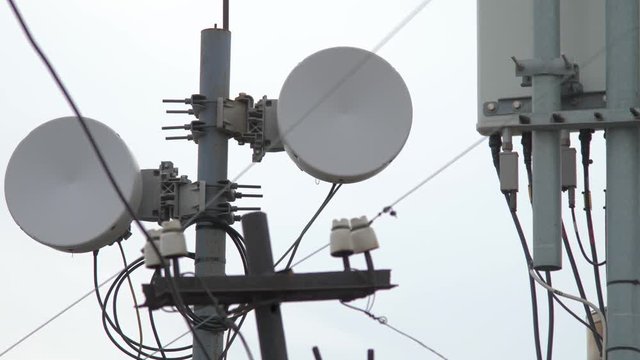 Telecommunication tower. Phone pole. Antenna on cloudy sky. Fibre-connected telecom tower. Cell phone and data communications tower. Ultra-high-speed data services background.