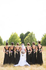 bridesmaids holding bouquets behind backs