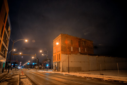 Urban winter street city night scene with vintage Chicago buildings and an empty lot