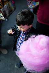  boy eats cotton candy at the fair