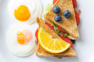 Breakfast - Sandwich with ham and tomatoes on plate