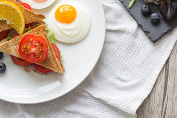 Breakfast - Sandwich with ham and tomatoes on plate