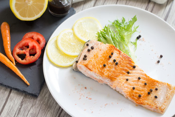 Grilled salmon with lemon and herb.