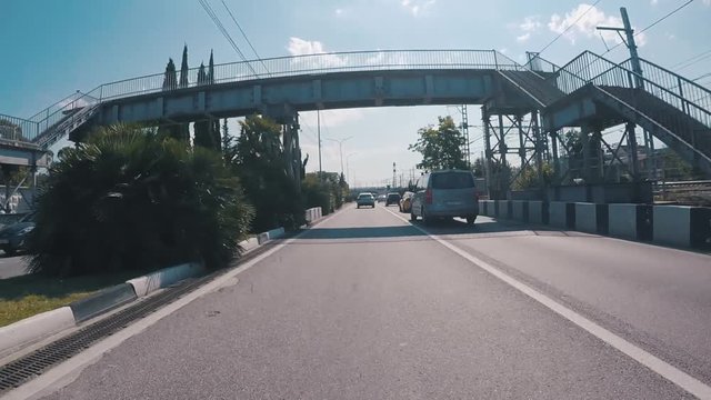 View from the motorcar on a road in Sochi near the railways. Scene. Krasnodar region, Russia.