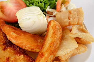Fish and Chips with vegatables isolated on white.