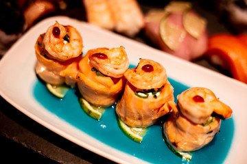 japanese food, salmon nigiri and shrimp on a black plate