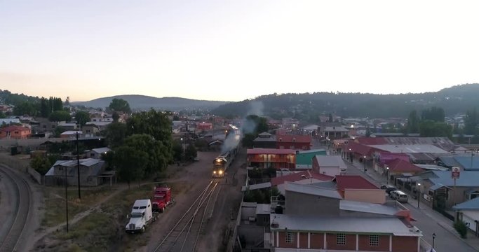 Aereal jib down shot of the El Chepe passenger train in Creel, Chihuahua, Mexico