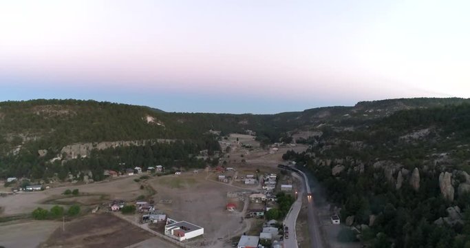 Aerial wide shot of the El Chepe passenger train in Creel, Chihuahua, Mexico