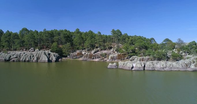 Aerial shot of the forest and rock formations of Arareco Lake in the Copper Canyon Region, Chihuahua.