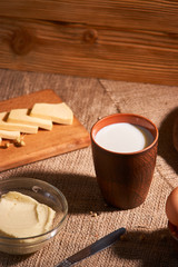 Assorted dairy products milk, cheese, butter rustic still life on table